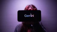 Person holding phone with Gemini logo