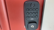 TCL D1 smart lock installed on red door